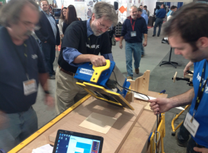 ShopBot Founder and CEO Ted Hall demonstrates the Handibot Smart Tool