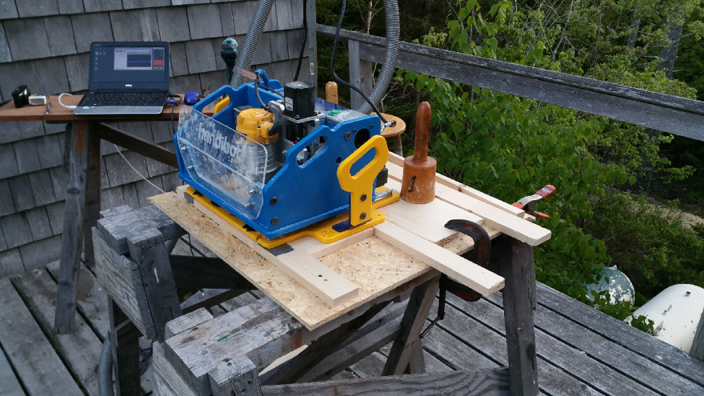 Handibot set up for tiling. Note project material against lower fence, clamped with wedge at top